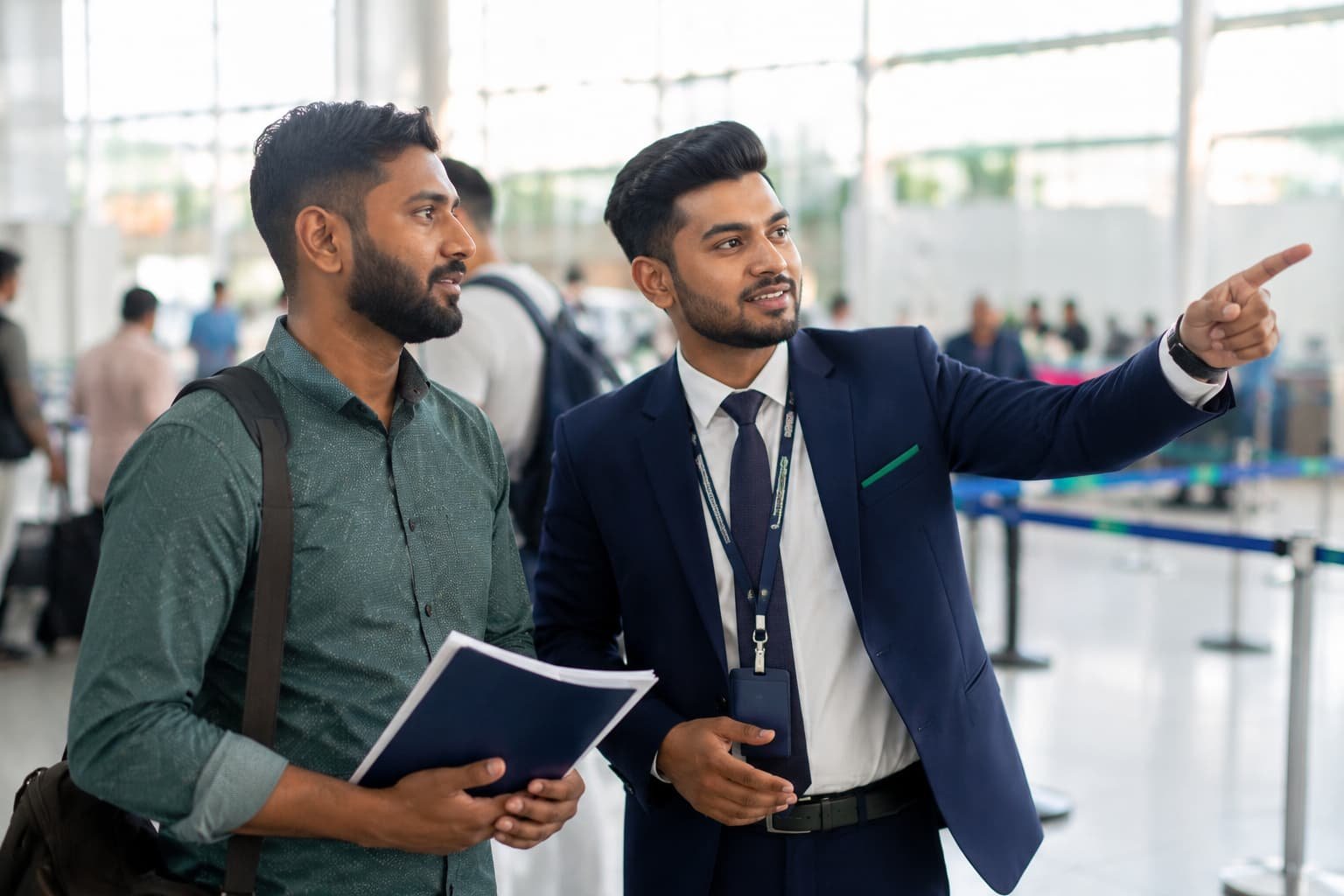 Airport representative assisting a traveller before the immigration queue